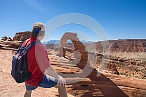 Man relaxing on top of the mountain on vacation hiking trip.