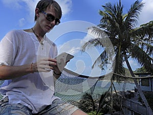 Man relaxing and use tablet computer at sea beach