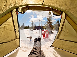 Man relaxing. Winter view from camping tent entrance out