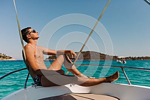 Man relaxing on yacht in the sea.