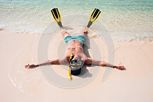 Man, relaxing in yellow black flippers fins and mask.