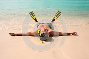 Man, relaxing in yellow black flippers fins and mask.