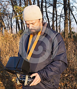 Man with Remote Control a dron in the park photo