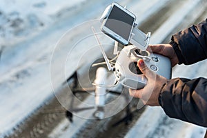 Man with remote control prepare white drone digital camera for start flying