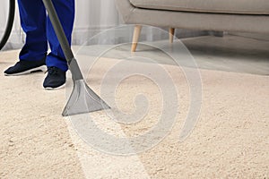 Man removing dirt from carpet