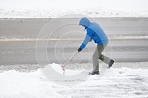 Man Removing Snow in His Driveway with a Shovel 3