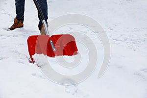 Man removing snow with shovel outdoors on winter day, closeup