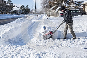 Man Removing Snow with a Snowblower on a Sunny Day 3