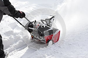 Man removing snow after storm with a snowblower