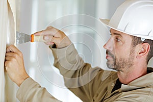 Man removing wall paper