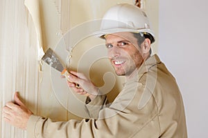 man removing wallpaper