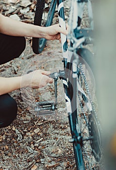 Man repair of a bicycle in the forest