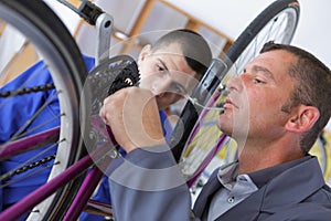 Man repairing bicycle chain