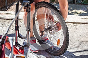 Man repairing a bicycle, preparing for the season, bicycle wheel