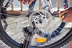 Man repairing a bicycle, preparing for the season, bicycle wheel