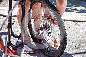 Man repairing a bicycle, preparing for the season, bicycle wheel