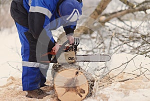 man repairing chainsaw