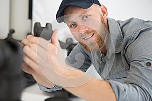 man repairing chair by hand with removable castors