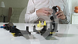 A man is repairing a coffee-making unit of a coffee machine, repair shop of coffee makers