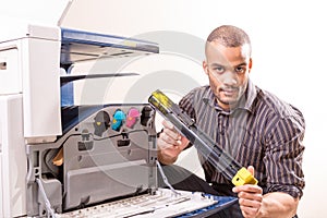 Man repairing color printer changing toner cartridge