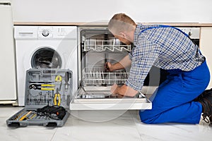 Man Repairing Dishwasher photo