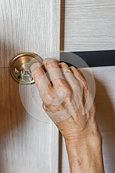 Man repairing the doorknob. closeup of worker`s hands installing new door locker