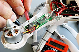 Man repairing drone. Fixing problems with quadrocopter