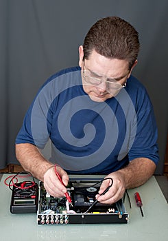 The man repairing DVD a player