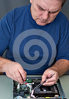 The man repairing DVD a player