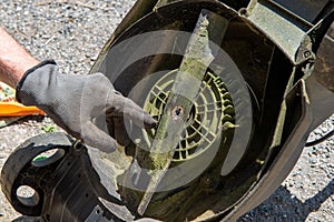 Man repairing an electric lawn mower