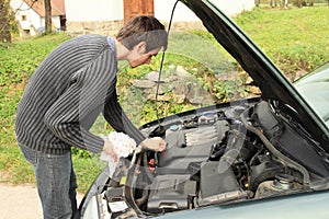 Man repairing engine of car