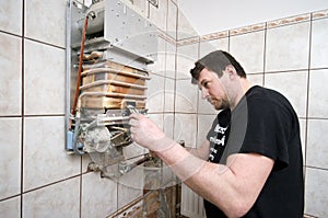 Man repairing gas furnace photo