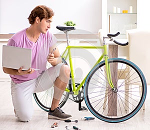 Man repairing his broken bicycle