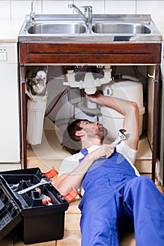 Man repairing kitchen sink