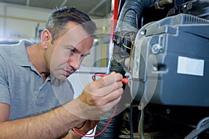 man repairing machine