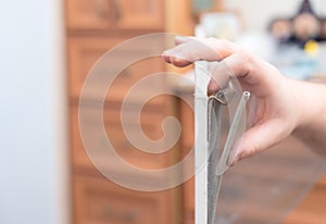 Man repairing mosquito net at home. Home improvement concept