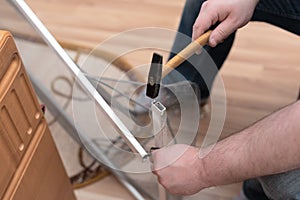 Man repairing mosquito net at home. Home improvement concept