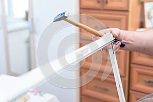 Man repairing mosquito net at home. Home improvement concept