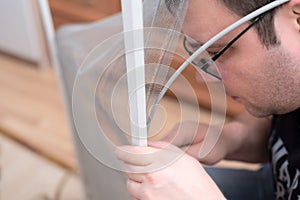 Man repairing mosquito net at home. Home improvement concept