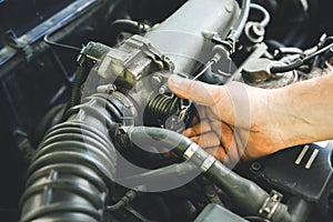 Man repairing old car engine. Inner details of machine