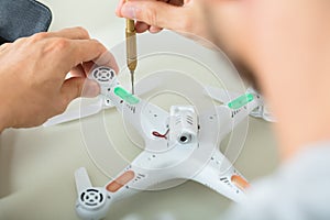 Man Repairing Quadrocopter Drone