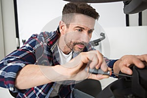 man repairing removable castors