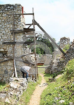 Man repairing of ruins of old monastery in Slovak Paradise