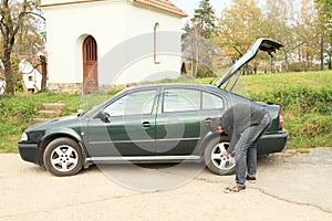 Man repairing wheal of car