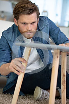 Man repairing wooden table