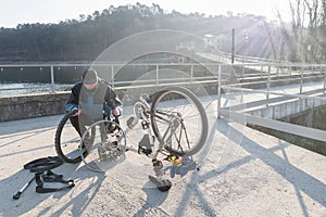 Man repairs a bicycle with flat tire. Concept of unforeseen