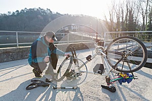 Man repairs a bicycle with flat tire. Concept of unforeseen