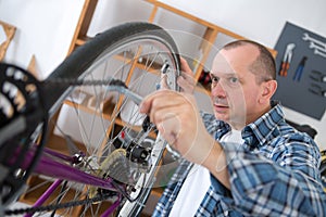 Man reparing bike in bicycle repair shop