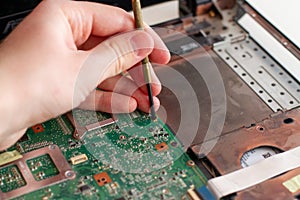 Man repearing a laptop circuit board. Laptop repair service