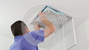 Man Replacing Ceiling Air Filter